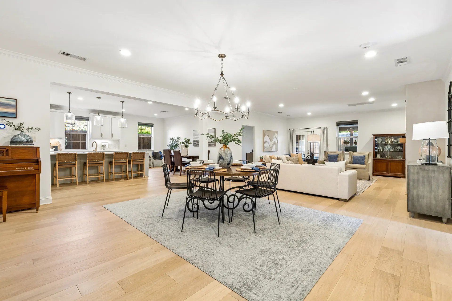 Open dining and living room in a North Dallas home prepared for listing photos