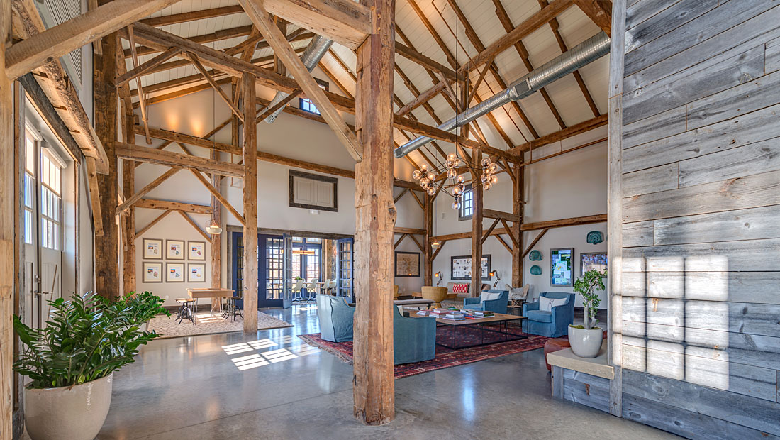 Light Farms community barn interior with rustic timber beams